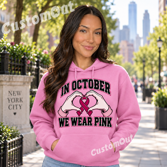 In October We Wear Pink Heart Ribbon Hoodie modeled on a woman in New York City
